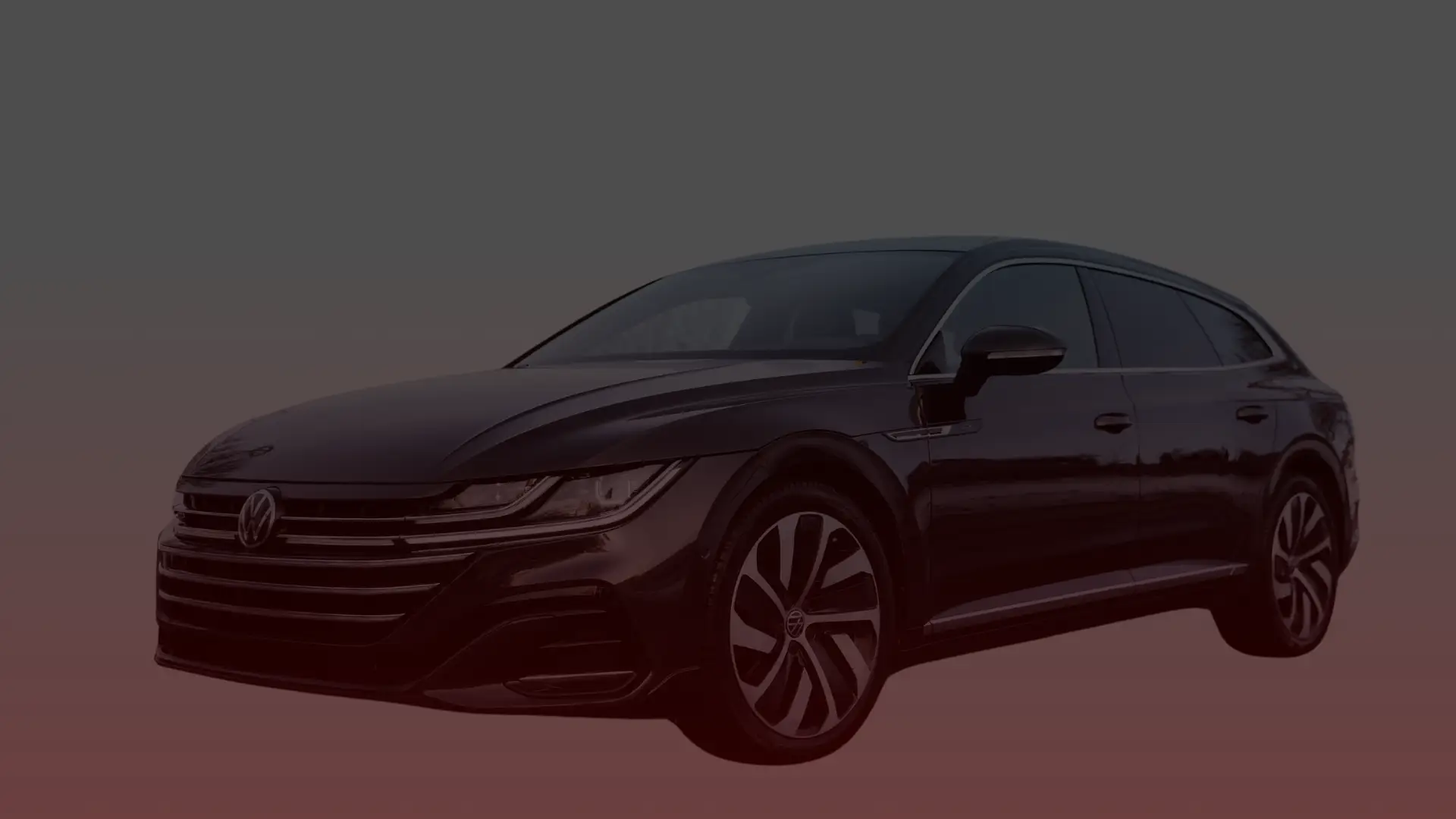 A sleek black Volkswagen Arteon wagon with distinctive, modern styling catches the eye. Featuring sharp headlights, a prominent front grille, and stylish alloy wheels, this masterpiece is worthy of any Volkswagen mechanic in Scarboroughs admiration against its gradient backdrop from dark to light red. EuroMechanic | Redline Automotive | Top Reviewed Auto Repair Shop in Scarborough | Visit redlineautomotive.ca