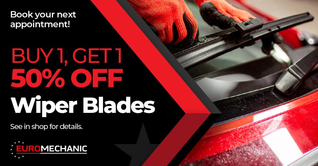 A person in red gloves replaces a wiper blade on a red car. Text advertises a “Buy 1, Get 1 50% off” wiper blades offer at EuroMechanic, and encourages booking an appointment. EuroMechanic - Redline Automotive | Top Reviewed Auto Repair Shop in Scarborough | Visit EuroMechanic - Redline Automotive